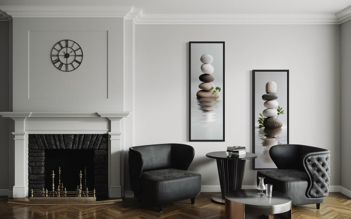 Set of two tall, narrow canvas prints featuring stacked zen stones in a modern minimalist room.