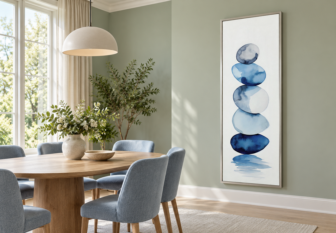 Tall narrow framed canvas wall art featuring navy blue and white stacked rocks in a dining room.
