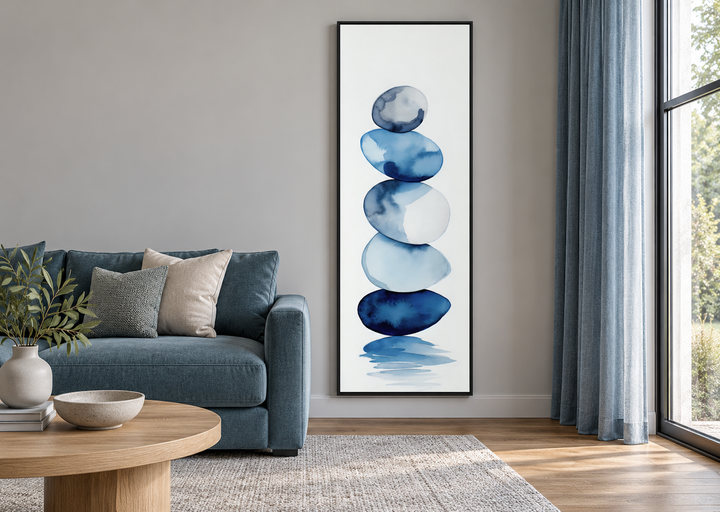 Tall narrow framed canvas wall art featuring navy blue and white watercolor stacked rocks.