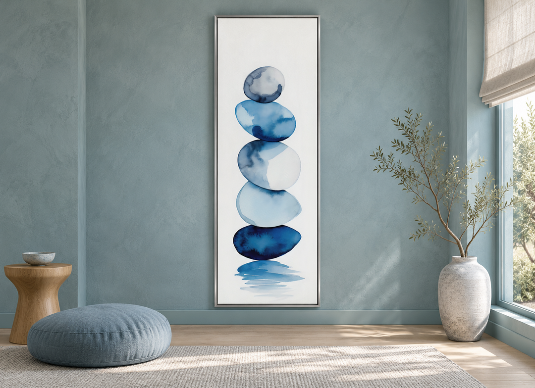 Tall narrow framed canvas wall art featuring navy blue and white watercolor stacked rocks.