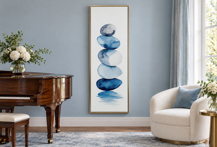 Tall narrow framed canvas wall art featuring navy blue and white watercolor stacked rocks.