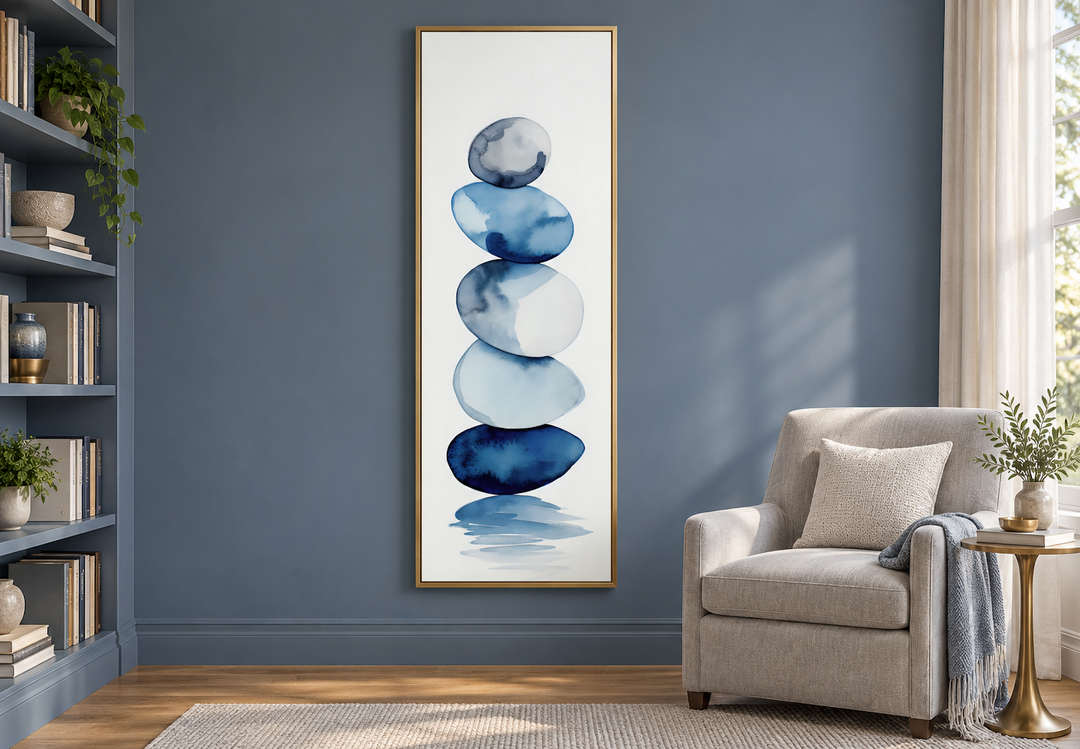 Tall narrow framed canvas wall art featuring navy blue and white watercolor stacked rocks.