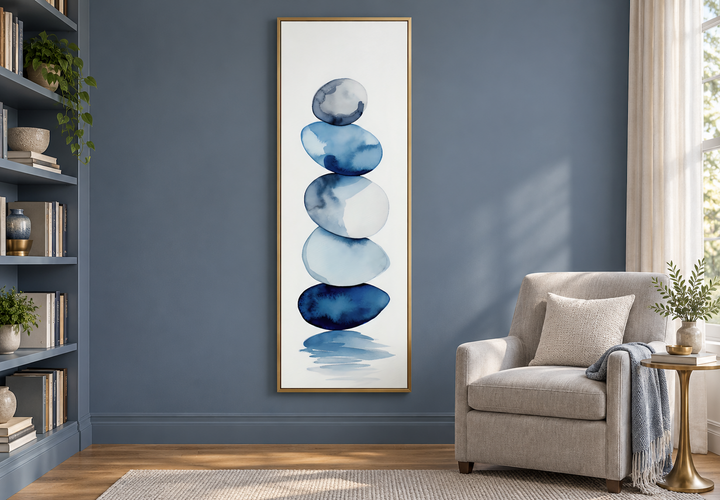 Tall narrow framed canvas wall art featuring navy blue and white watercolor stacked rocks.