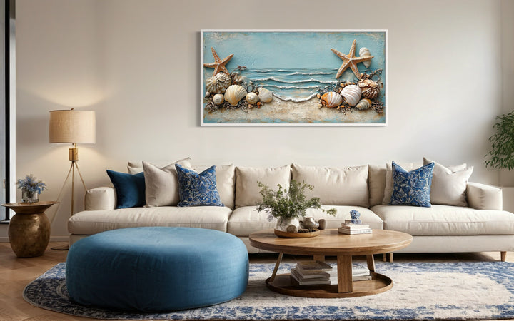 Framed canvas wall art featuring starfish and seashells in soft blue and sandy beige tones.