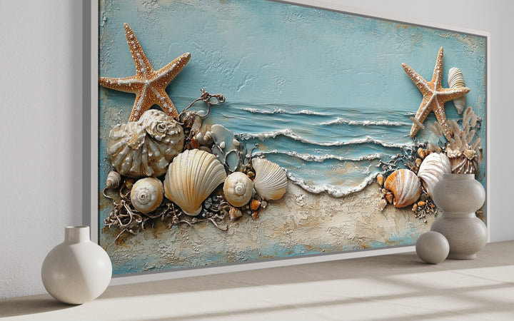 Framed canvas wall art featuring starfish and seashells in soft blue and sandy beige tones.