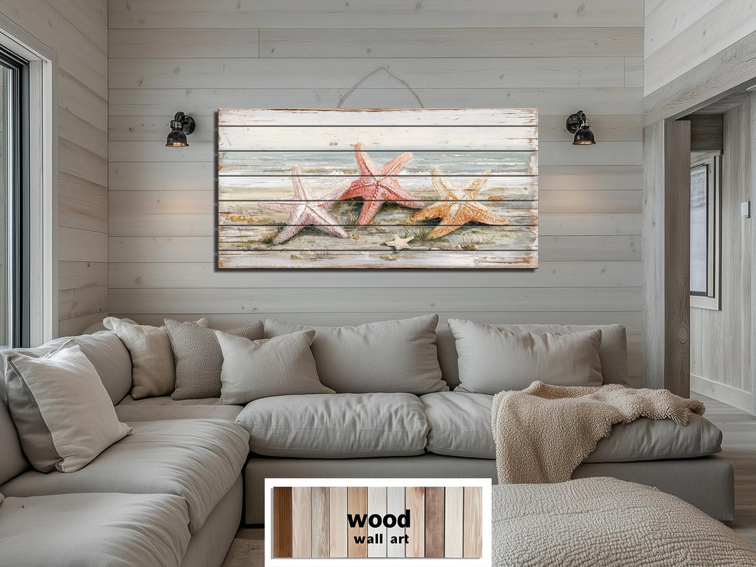 Large horizontal wood wall art featuring three starfish on a sun-bleached beach.