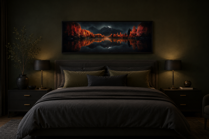 Starry night sky over mirror lake in autumn wall art hanging above a bed in a dark bedroom.