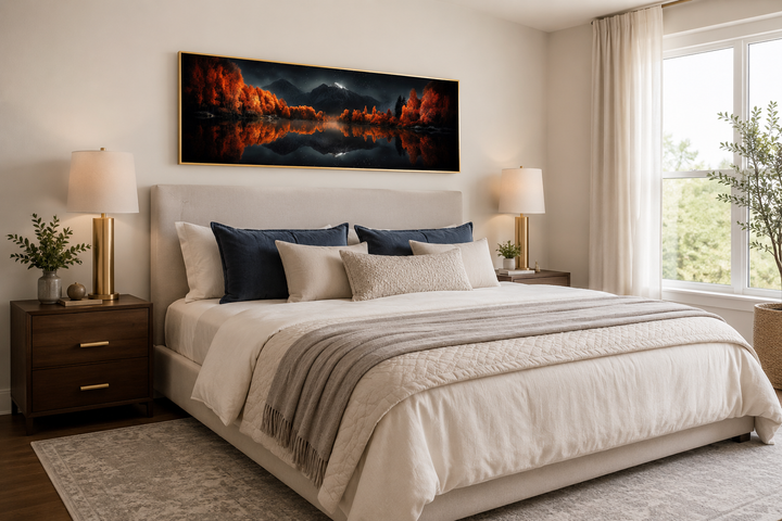 Starry night sky over mirror lake in autumn wall art above a bed in a modern bedroom.