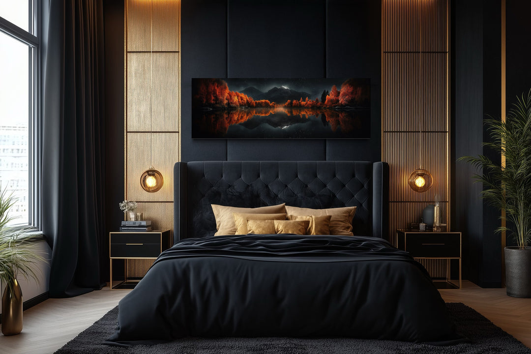 Starry night sky over mirror lake in autumn canvas art above a black tufted bed in a modern bedroom.