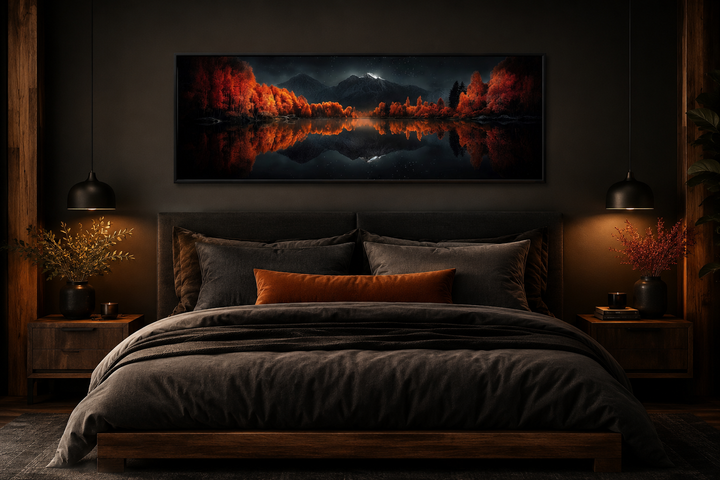 Starry night sky over mirror lake in autumn wall art hanging above a bed in a dark bedroom.