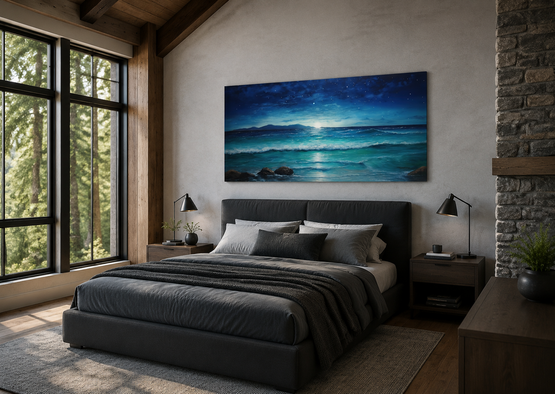 Panoramic framed canvas of a starry night sky over ocean waves above a dark grey bed.