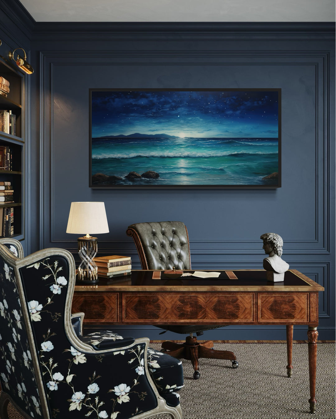 Framed panoramic canvas of a starry night over a coastal ocean beach in a dark blue office.