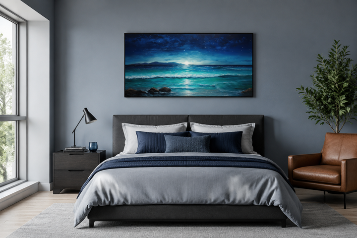 Framed panoramic canvas of a starry night over ocean waves above a bed in a modern bedroom.