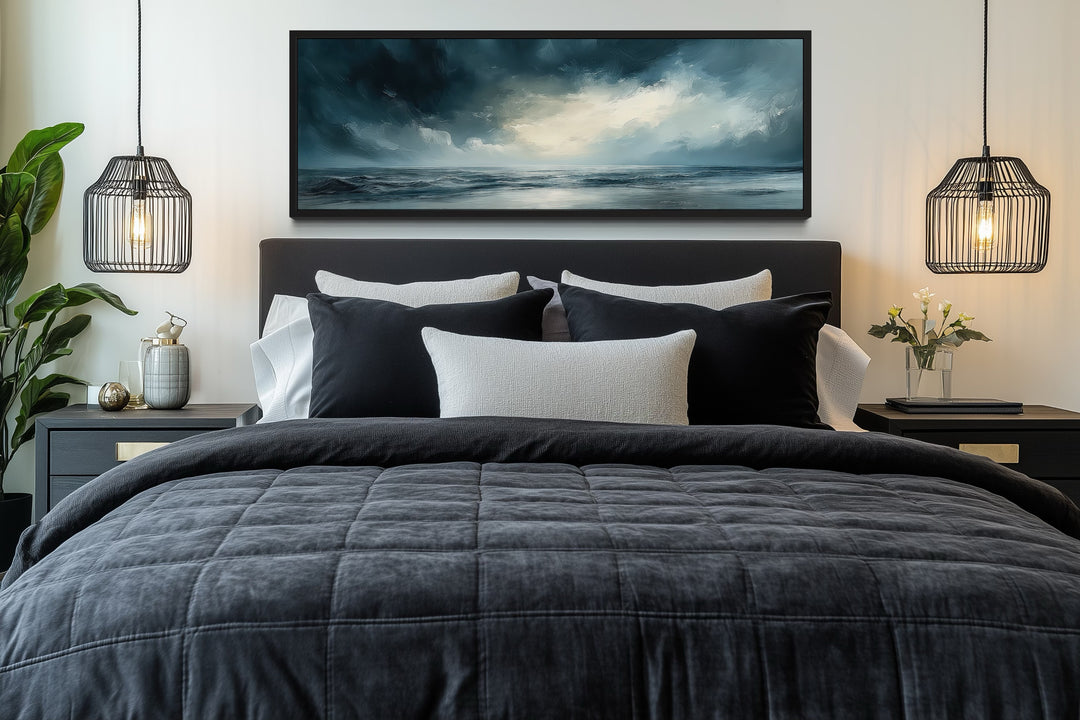 Stormy Horizon Over The Ocean panoramic canvas wall art hanging above a modern dark-toned bed.