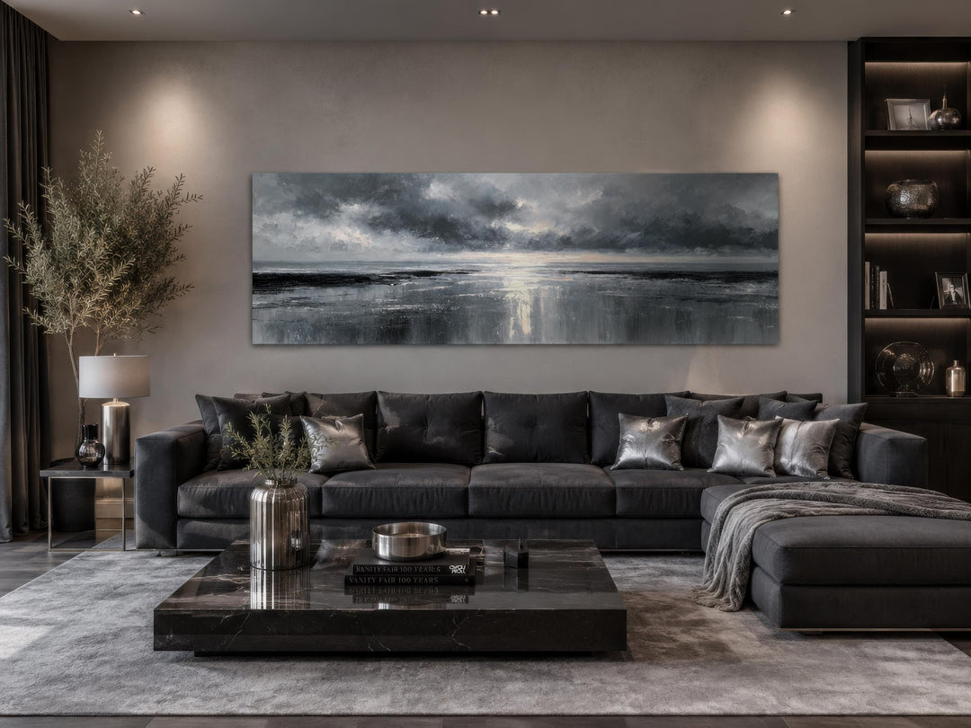 Stormy Ocean long horizontal grey and silver canvas wall art above a dark grey sofa in a living room