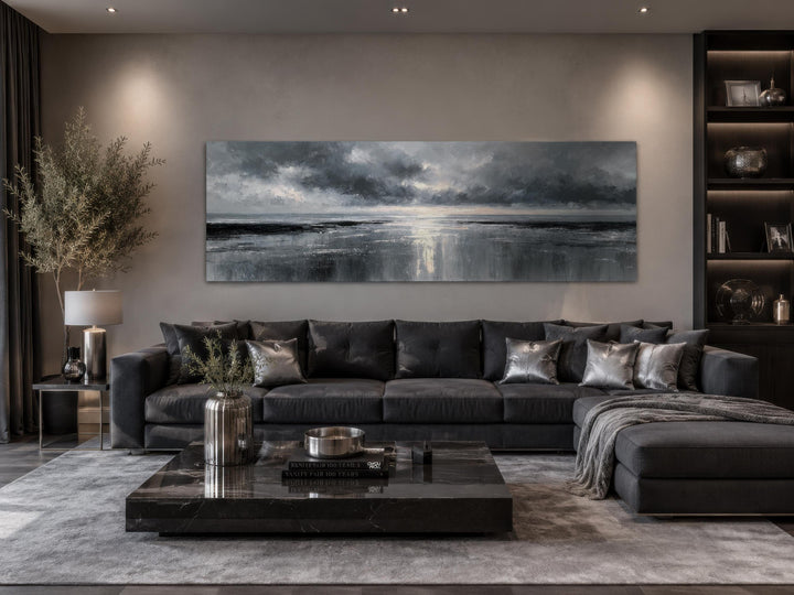 Stormy Ocean long horizontal grey and silver canvas wall art above a dark grey sofa in a living room