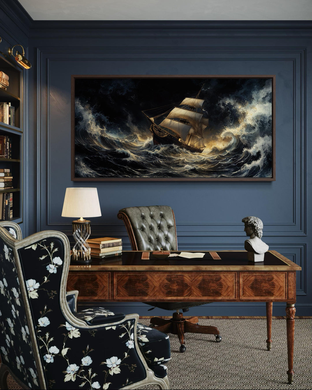 A framed canvas print of a sailing ship navigating a stormy ocean on a dark blue paneled wall.