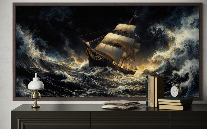 A framed canvas print of a sailing ship navigating dramatic, stormy ocean waves above a console.