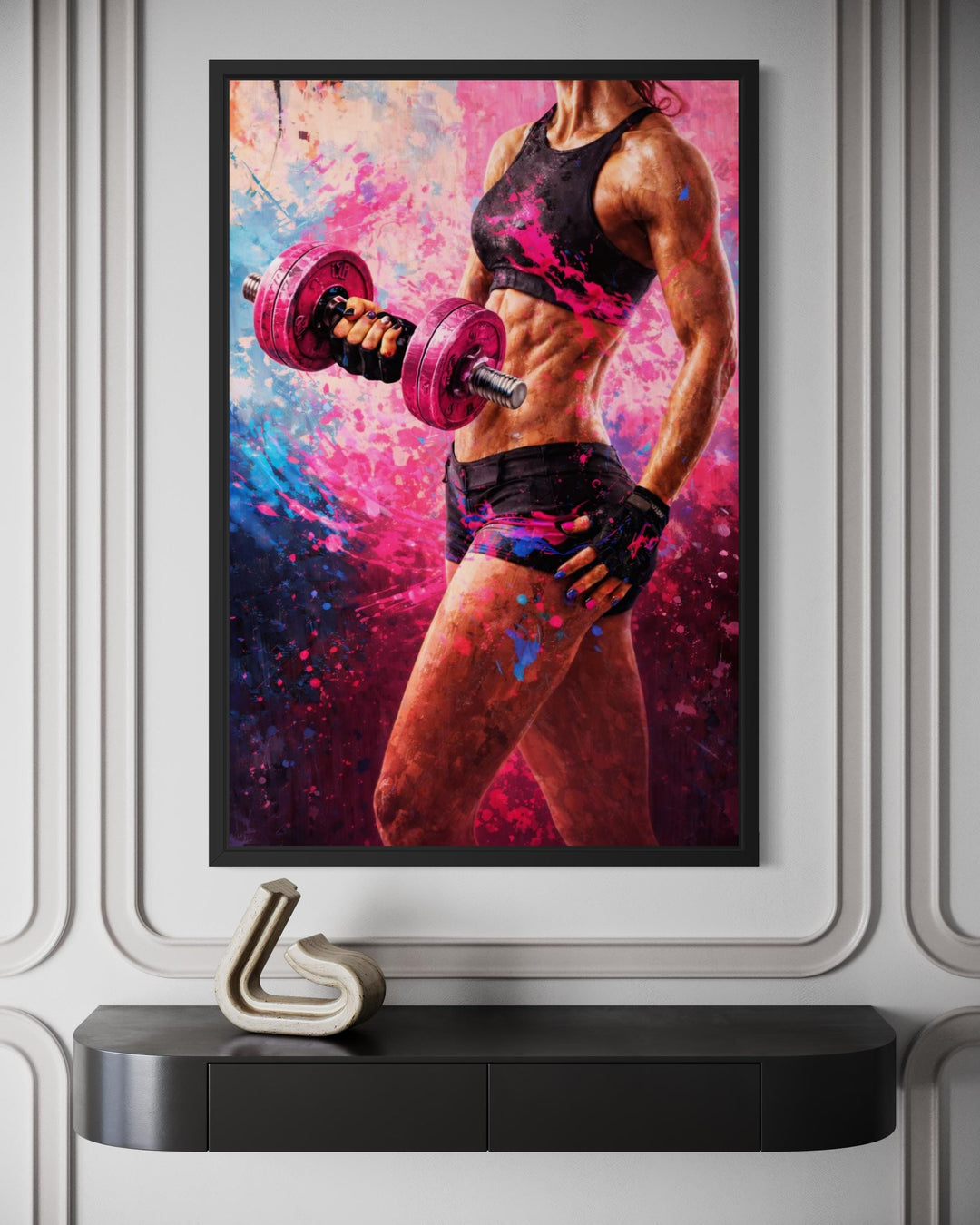 A framed canvas print of a muscular woman lifting a pink dumbbell with vibrant paint splatter art.