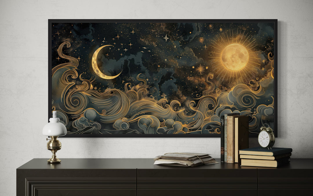 Framed black and gold celestial canvas art featuring a sun, crescent moon, and swirling clouds.