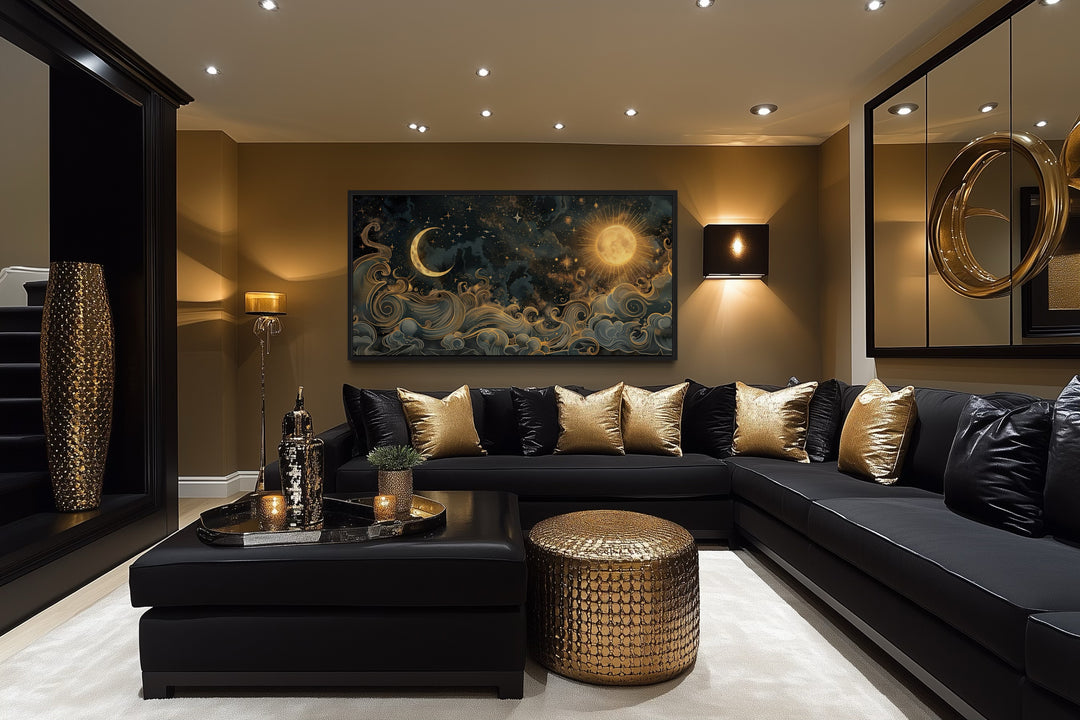 Framed black and gold celestial canvas wall art featuring a sun and moon above a black sofa.
