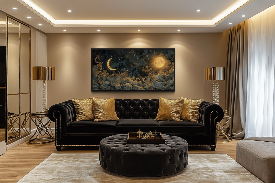 Framed black and gold sun and moon celestial canvas wall art hanging above a black velvet sofa.
