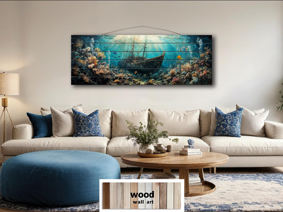 Sunken shipwreck scene printed on a horizontal distressed wood wall art panel above a sofa.