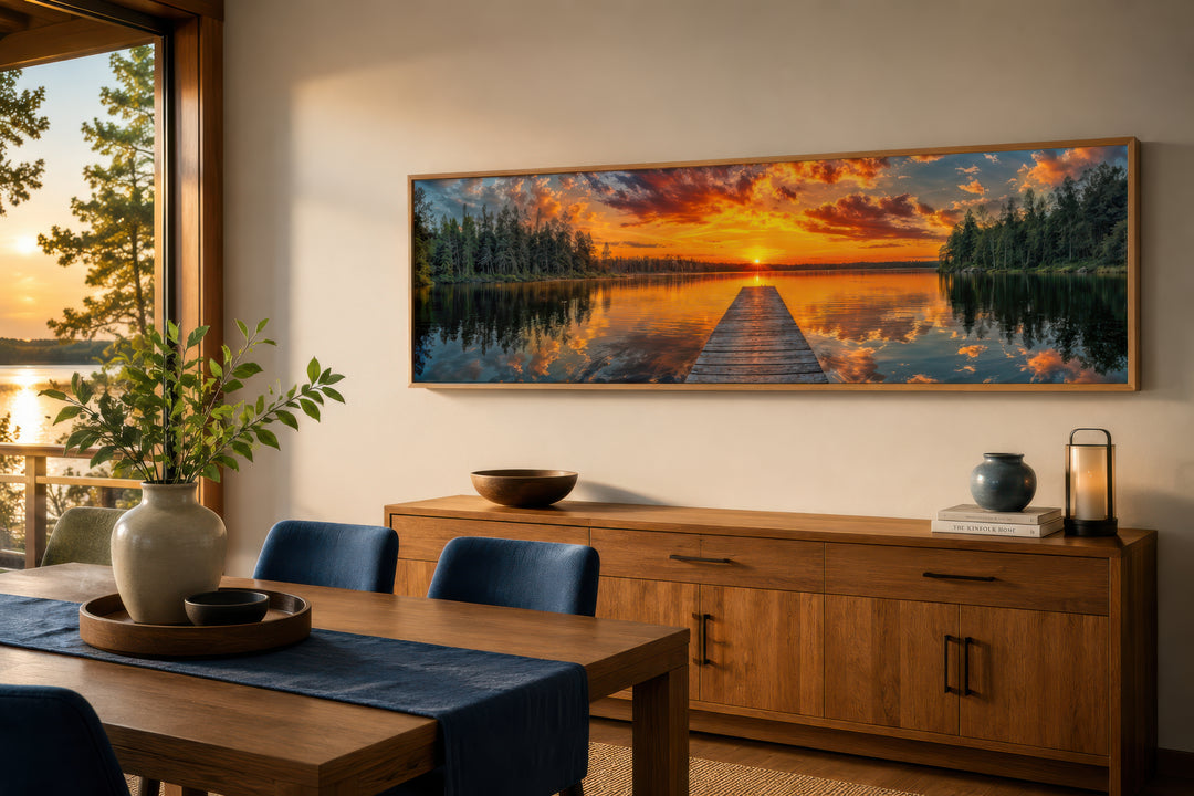 Sunrise over lake and fishing pier long horizontal canvas wall art above a wooden sideboard.