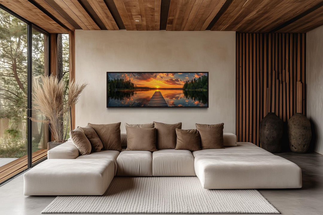 Sunrise over lake and fishing pier long horizontal canvas wall art above a modern sofa.