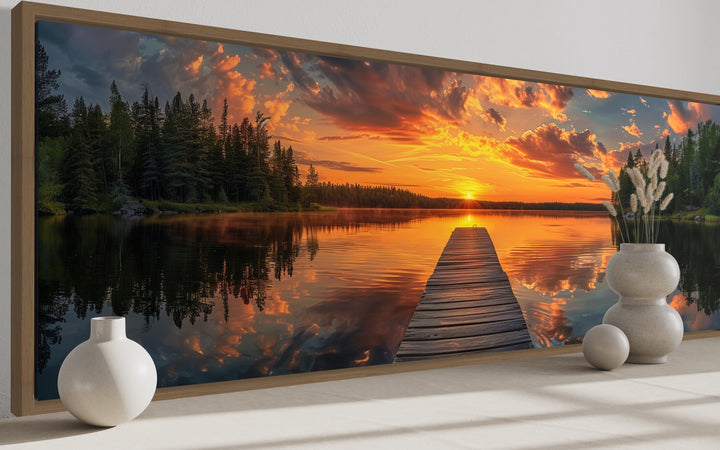 Sunrise over lake and fishing pier long horizontal canvas wall art in a wooden frame.
