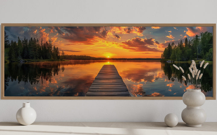 Sunrise over lake and fishing pier long horizontal canvas wall art above a console table.