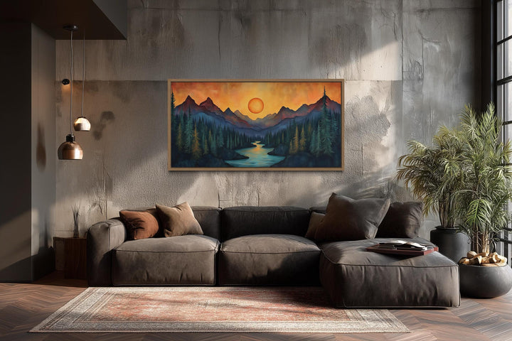 Sunset mountain river painting on wood canvas wall art above a brown sofa in a modern rustic room.