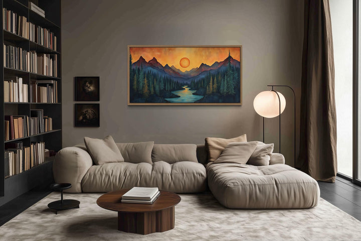 Sunset Mountain River canvas wall art above a beige sofa in a modern rustic living room.