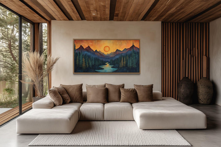 Sunset mountain river painting on wood canvas wall art above a modern sofa in a rustic cabin.