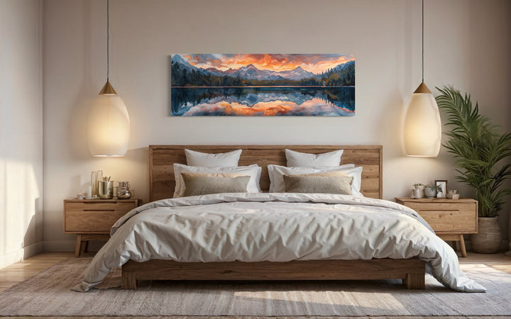 Panoramic sunset mountain lake canvas wall art hanging above a wooden bed in a modern bedroom.