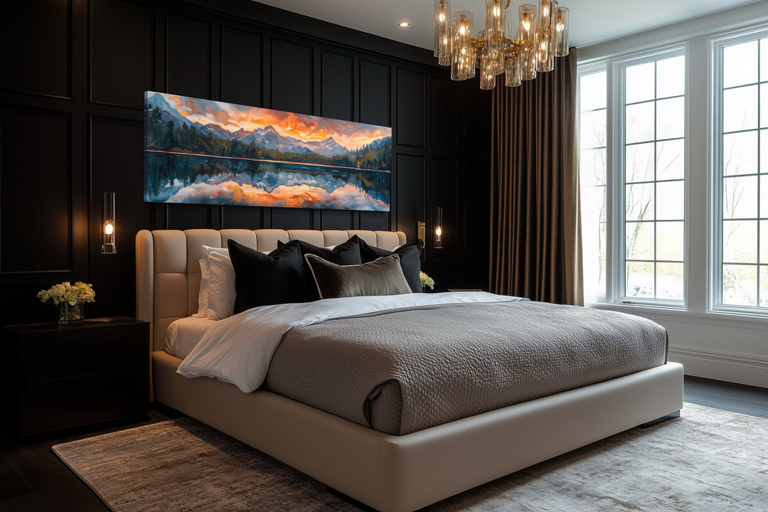 Sunset over mountain lake panoramic framed canvas wall art hanging above a bed in a dark bedroom.