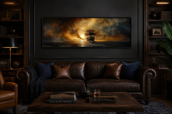 Sunset sailing ship long horizontal canvas wall art above a leather sofa in a dark study.