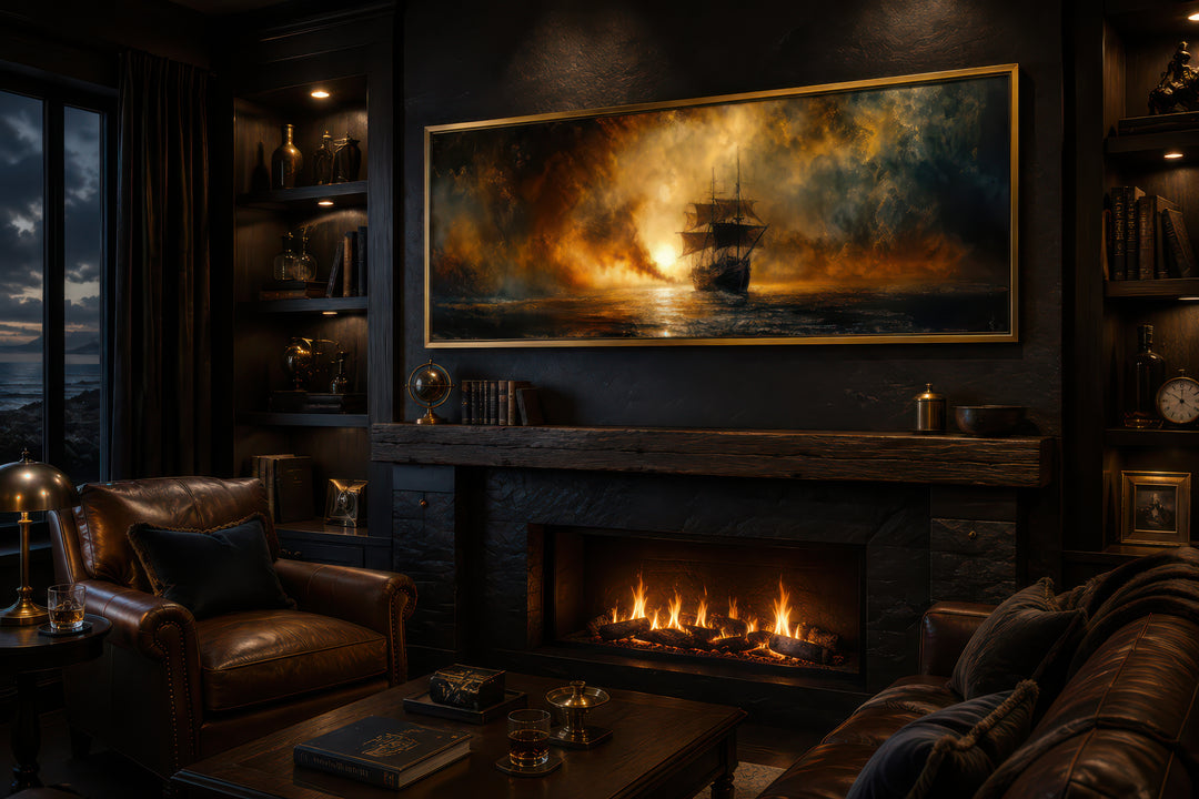 Sunset sailing ship canvas wall art in a gold frame above a fireplace in a dark, cozy room.