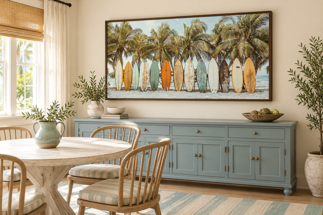 Surfboards On The Beach Framed Canvas Wall Art above a blue sideboard in a coastal dining room.