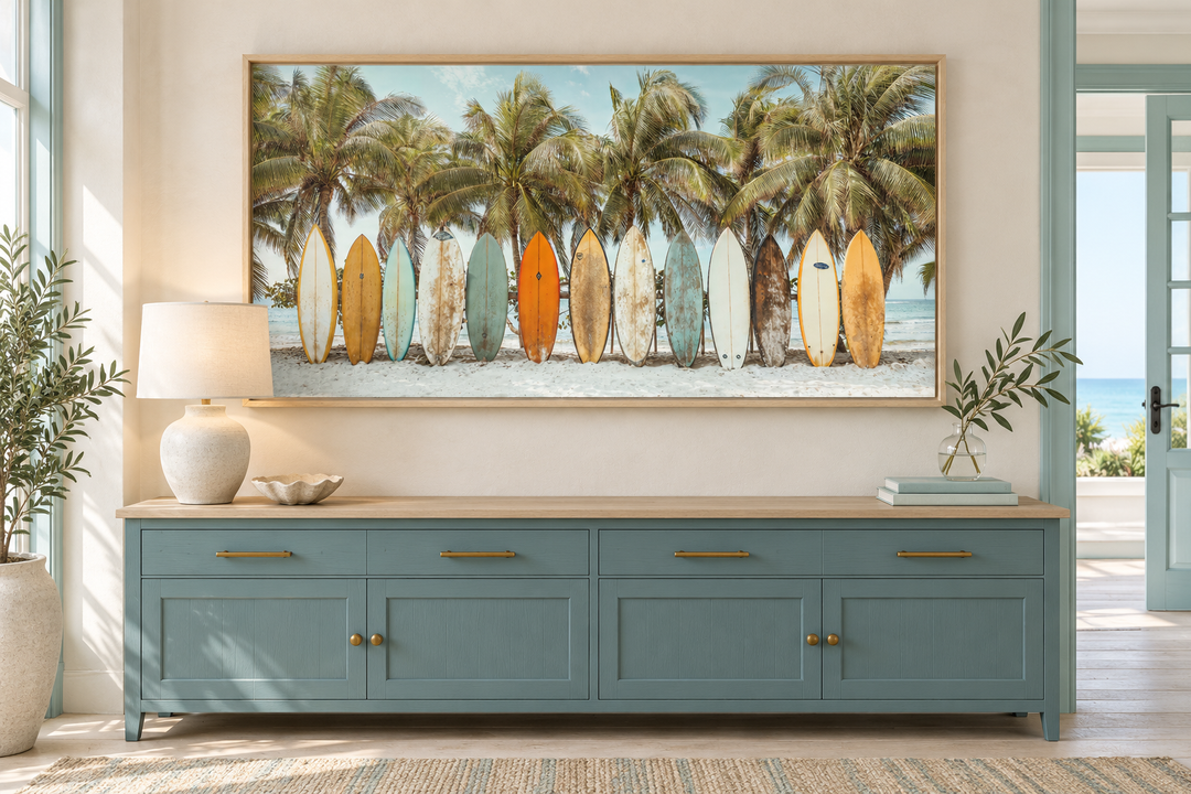 Surfboards On The Beach Framed Canvas Wall Art above a blue sideboard with palm trees and sand.