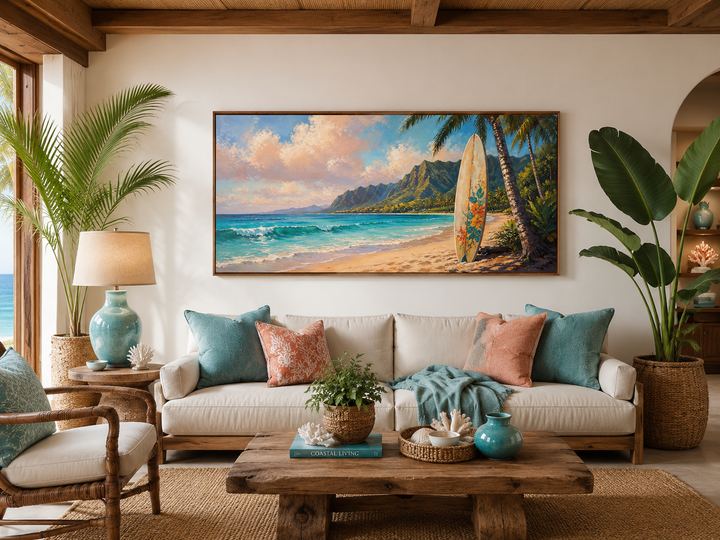 Framed canvas wall art of a surfboard on a Hawaiian beach at sunset above a white sofa.