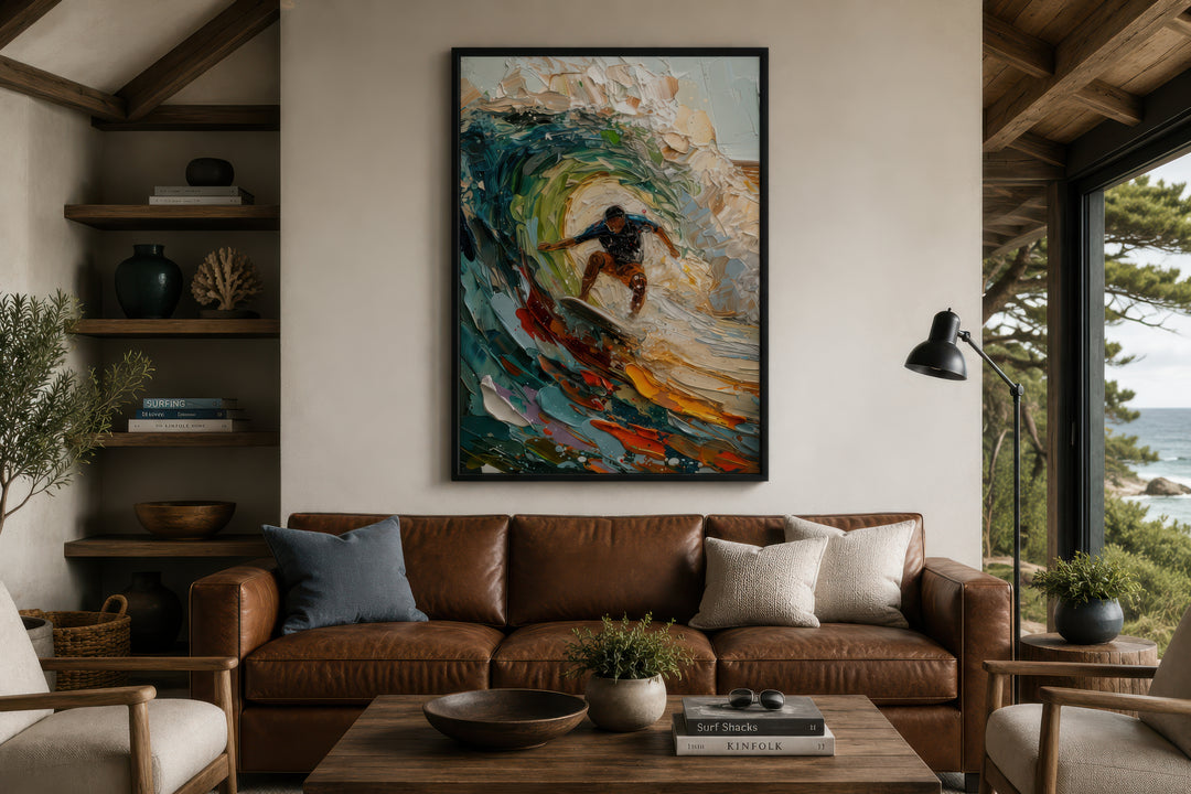 A framed impressionistic canvas painting of a surfer riding a colorful, textured wave.