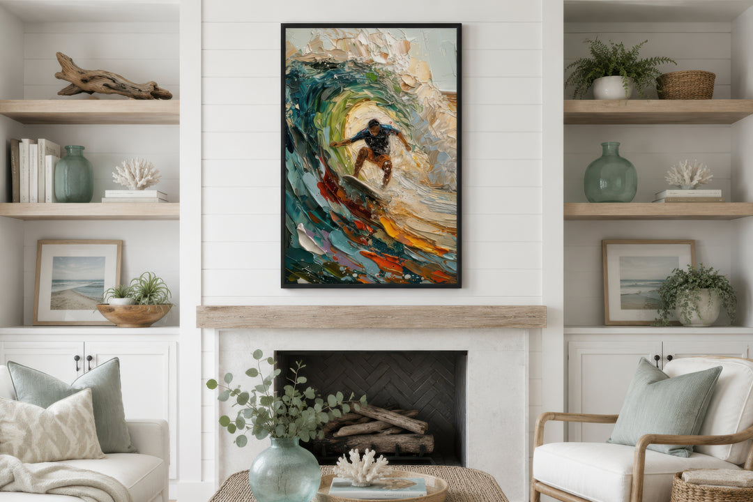 A framed impressionistic canvas painting of a surfer riding a colorful wave above a fireplace.