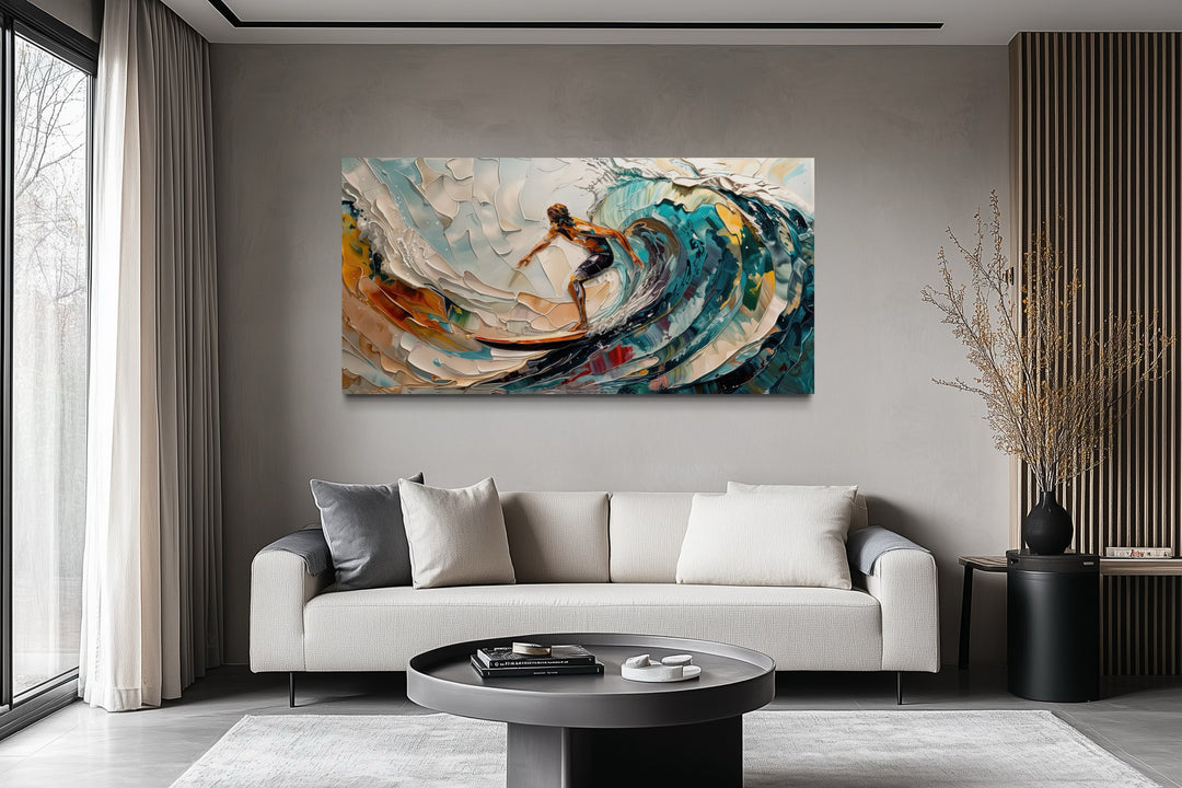Abstract surfer canvas art with vibrant ocean wave painting hanging above a modern sofa.