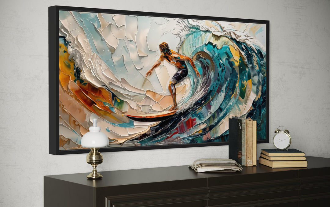 Abstract canvas wall art of a surfer riding a vibrant, textured ocean wave in a black frame.