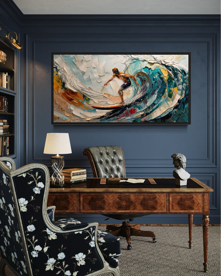 Abstract surfer canvas painting with vibrant ocean waves hanging in a dark blue office setting.