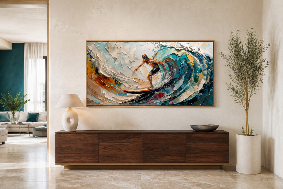 Abstract surfing wall art of a surfer on a vibrant blue wave above a dark wood sideboard.