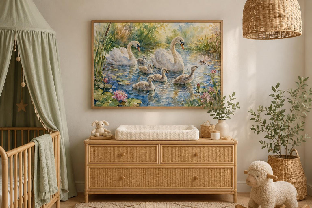Swan family with cygnets painting in a wooden frame above a dresser in a neutral-toned nursery.