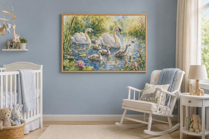 Framed canvas of a swan family with cygnets on a pond, hanging in a blue-walled nursery.