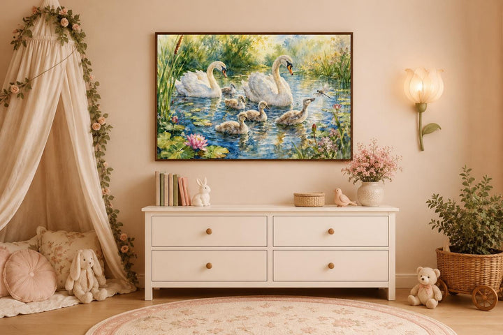 Swan family with baby cygnets canvas print hanging above a white dresser in a nursery.